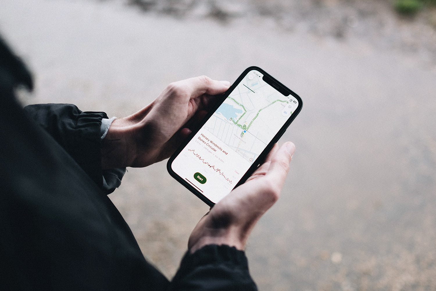 a close-up image of someone using a smartphone to navigate a circular walk at horsey