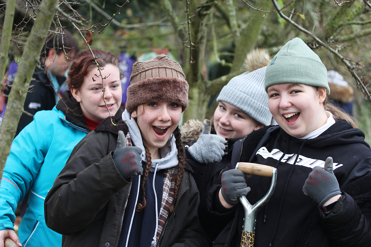 Young people doing conservation work outdoors during the first Generation Green project